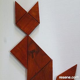 Create a classic wooden tangram puzzle of a cat