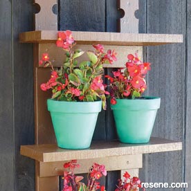 Make some simple outdoor shelves for displaying potted plants