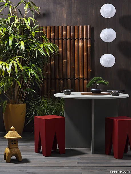 Dramatic outdoor dining area featuring dark wood stains
