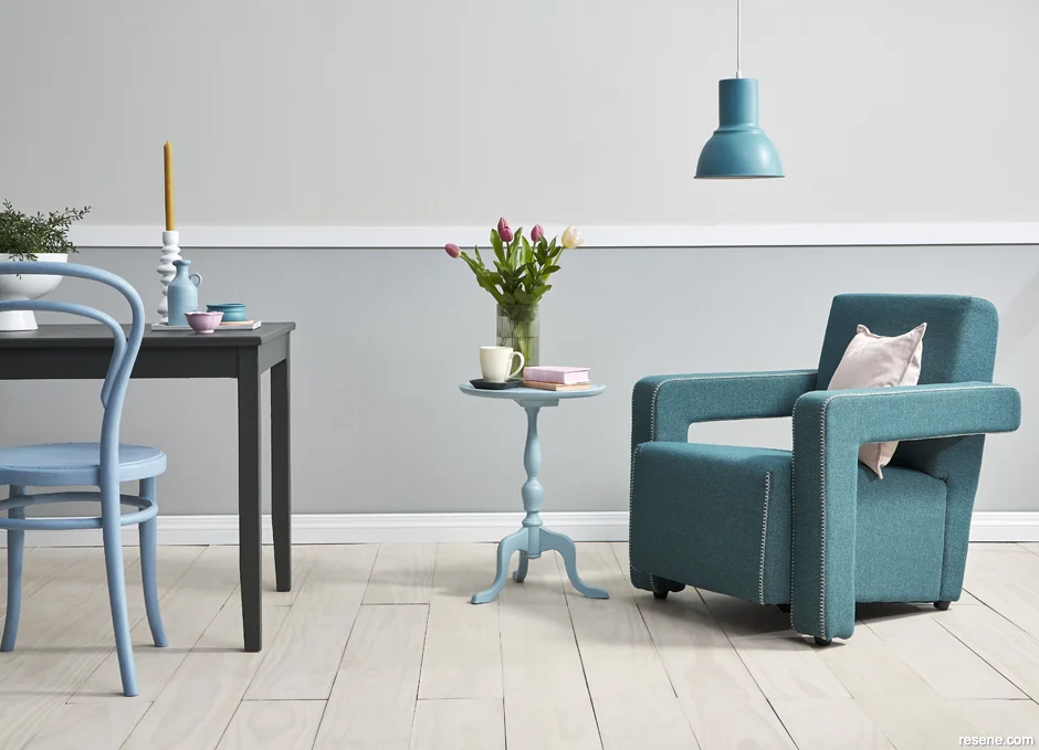 Sitting room with grey walls and blue accents on furniture and accessories