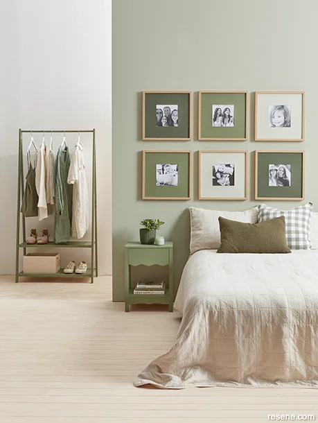 Neutral bedroom with a wall painted in a pared-back green
