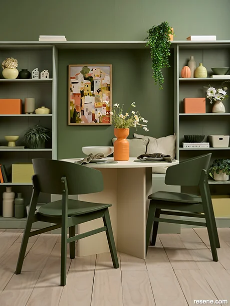 Soft green dining room with muted orange and peach accents