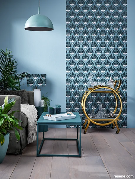 An Art Deco Style lounge with grey-blue walls and lush house plants