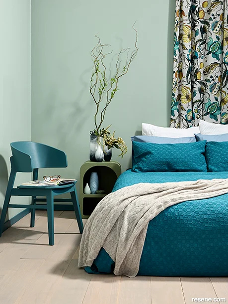 A bedroom painted with summery blue and green hues