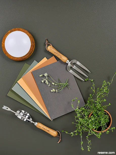 A chic moodboard showing dark hues and garden accessories for a wellness deck