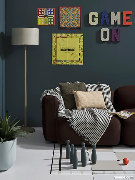 A rumpus room painted with dark and moody hues – deep earthy grey