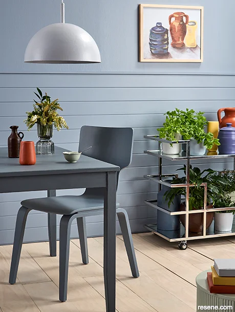 A dining space with bold and vibrant coloured accessories that provide warmth