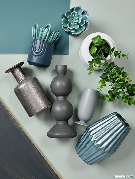 DIY crate shelving moodboard with green and blue paint swatches and metallic-finished accessories