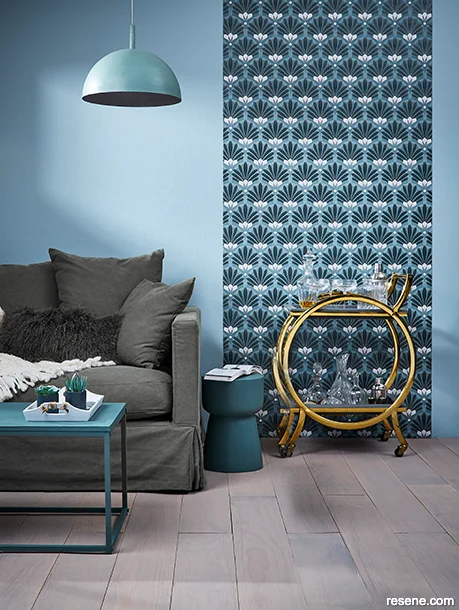 A lounge using bold Art Deco style geometric wallpaper