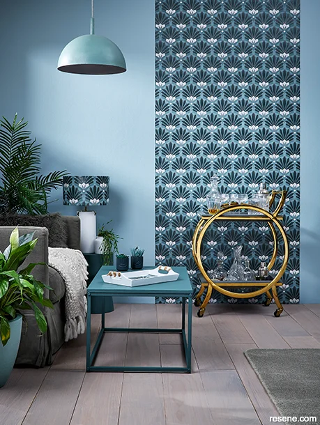 A lounge in a modern Art Deco style - rounded furniture and bold geometric wallpaper