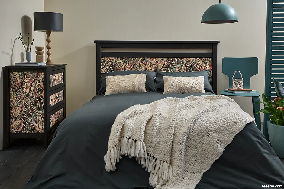 A neutral bedroom with wallpapered drawers and headboard