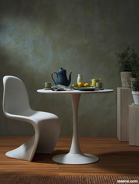An outdoor dining area painted with modern moody hues