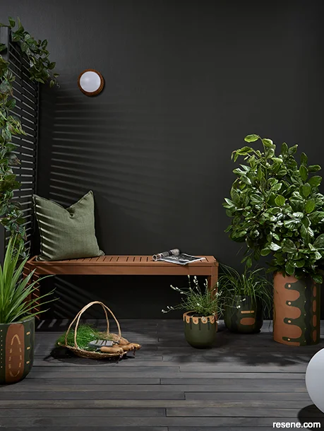 A relaxing wellness deck with lush plants and green accessories