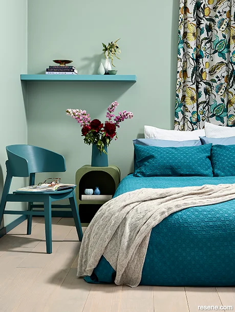 A soothing summery bedroom with NZ native bird pattern curtains
