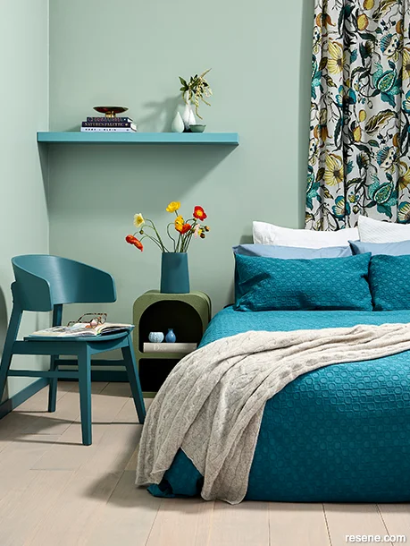 A soothing summery style bedroom painted in green and blue hues
