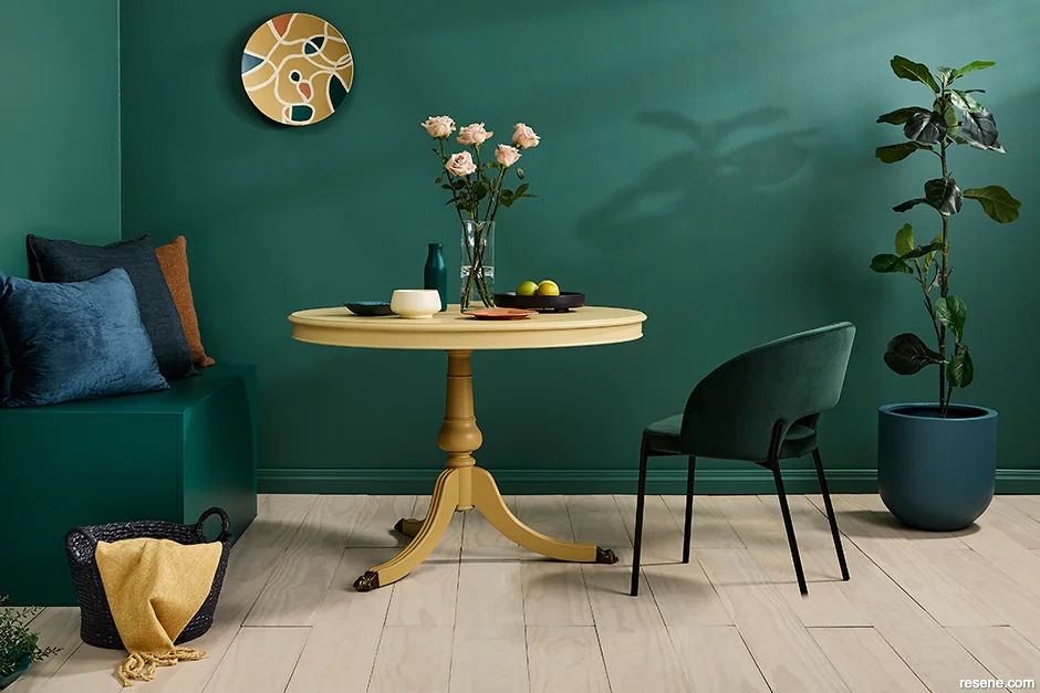 A sophisticated dining room saturated with emerald hued Resene Stromboli
