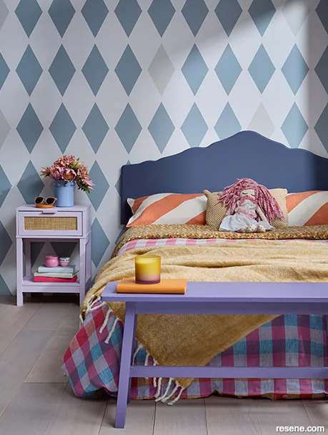 A teen bedroom with a bold painted wall pattern