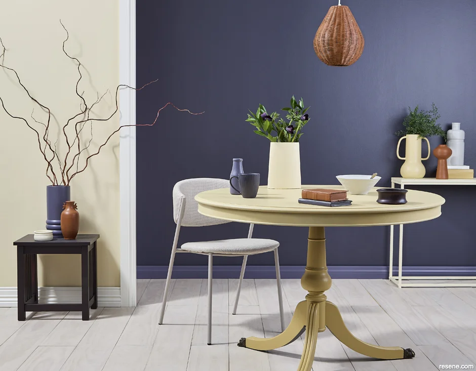 An intimate and vibrant dining room painted with light and dark hues