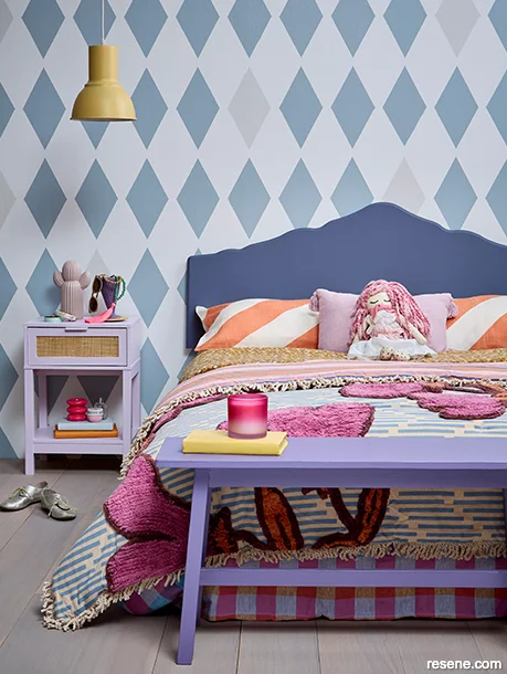 A teen bedroom painted with vibrant colours and bold patterns