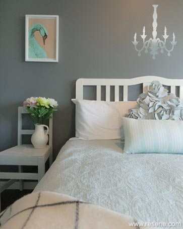 A bedroom with a grey colour sheme
