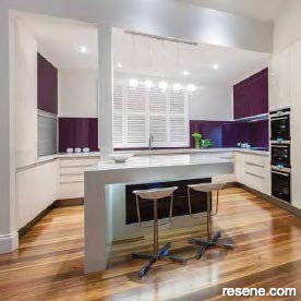 A white kitchen with colourful detailing.