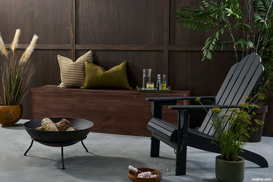 Warm outdoor room utilising greenery and cosy textiles