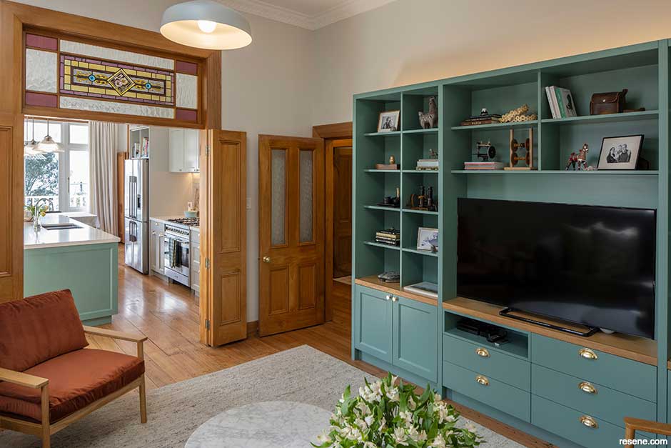 Green kitchen island and cabinetry in Resene Cutty Sark