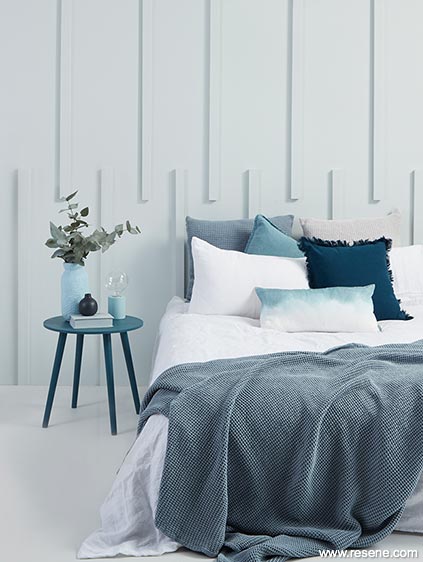 A bedroom with unique batten walls