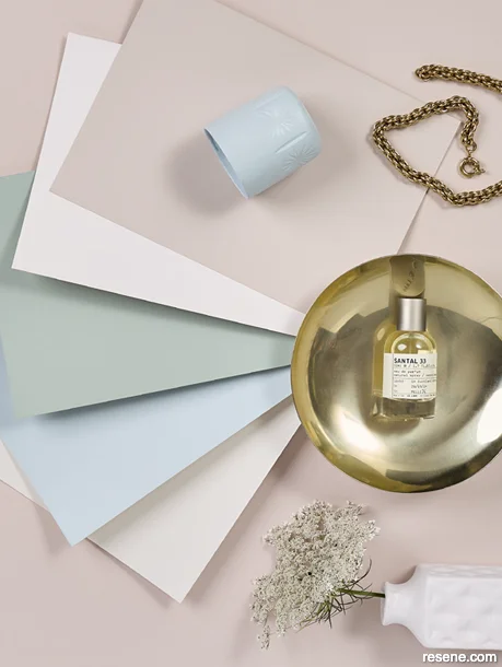 Soothing moodboard with light pink, blue and green paint swatches and delicate white flowers