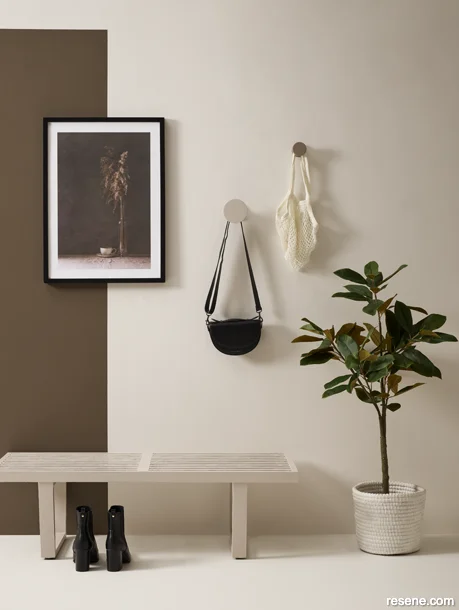 An entranceway styled in a monochromatic palette with layered neutral tones