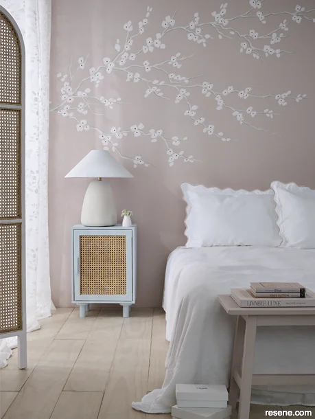 Powder pink bedroom with a floral wall mural