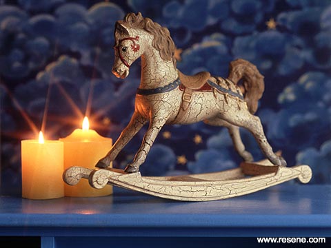 A rocking horse ornament with a crazed paint finish