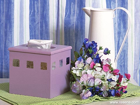Applying metal leaf on a tissue box