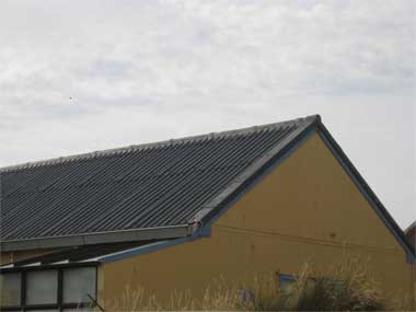 Asbestos containing roofing and cladding