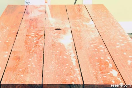 Rinsing the outdoor furniture after cleaning