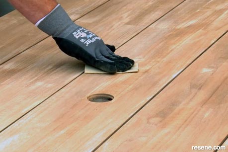Lightly sanding outdoor furniture