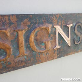 Embossed copper sign