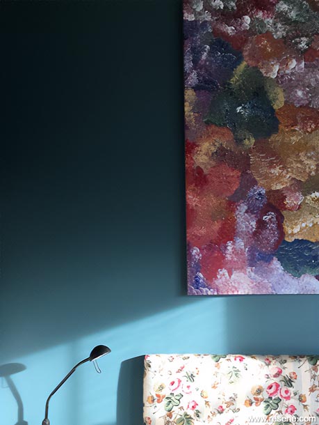 A dark blue villa bedroom