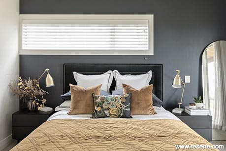 A dark blue and white guest bedroom