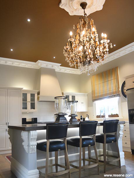A villa kitchen in white and a rich coffee cream
